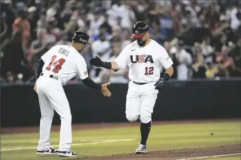  ?? GODOFREDO A. VÁSQUEZ/AP ?? UNITED STATES’ KYLE SCHWARBER (RIGHT) celebrates with third base coach Dino Ebel after hitting a three-run home run against Great Britain during the fourth inning of a game in Phoenix, on Saturday.