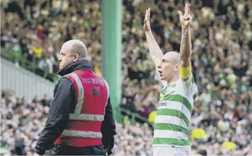  ??  ?? 0 Scott Brown, with an eight-in-a-row hand gesture, taunts the 800 Rangers supporters at Celtic Park after Sunday’s Old Firm derby.