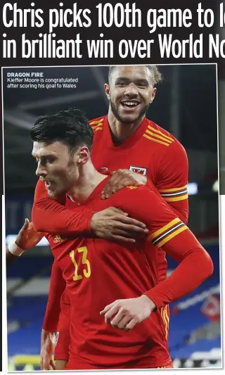  ??  ?? DRAGON FIRE
Kieffer Moore is congratula­ted after scoring his goal fo Wales