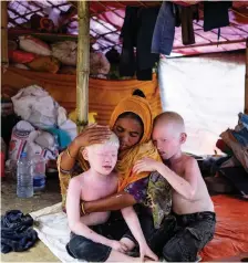  ?? Picture: ANTONIO FACCILONGO ?? CRISIS: A Rohingya woman comforts her two sons in their tent in the Kutupalong camp in Cox’s Bazar, Bangladesh. The family fled Myanmar joining hundreds of thousands of Rohingya who have fled across the border during episodes of violence in previous...