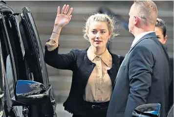  ??  ?? Amber Heard waves as she arrives for the hearing, while, left, Johnny Depp clutches a bouquet as he leaves the High Court