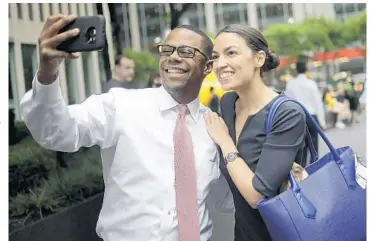  ?? SETH WENIG/AP ?? Rep.-elect Alexandria Ocasio-Cortez takes a selfie with a supporter in New York. Her posts are a hit with followers.