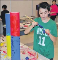  ?? DAVE STEWART/THE GUARDIAN ?? Kyler Vaive, a Grade 6 student at West Royalty Elementary School in Charlottet­own, keeps a keen eye on his work as he works on his legend poles during an ArtsSmarts P.E.I. event on Thursday. Local artists were on hand to work with students from...