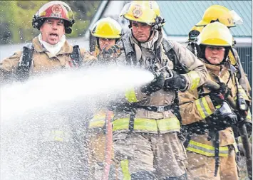  ?? TRURO DAILY NEWS PHOTO ?? Fire ghters work as a team as they converge on a simulated propane tank re during live re training in Valley. Several di erent situations provided by Draeger Safety Canada gave re ghters a taste of the real thing.