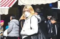  ?? (Olivier Fitoussi/Flash90) ?? A WOMEN wearing a face mask walks in Mahaneh Yehuda earlier this week.