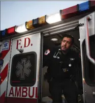  ?? JOHN MINCHILLO — ASSOCIATED PRESS ?? In this April 23 photo FDNY paramedic Alex Tull, who has recently recovered from COVID-19, prepares to begin his shift outside EMS station 26, the “Tinhouse,” in the Bronx borough of New York.