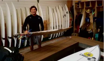  ?? DR. JOHN JONES VIA AP ?? Mr. Jones in 2019 at Surf Ranch in Lemoore, Calif., holding a surfboard his brother Daniel made using material from the agave plant.