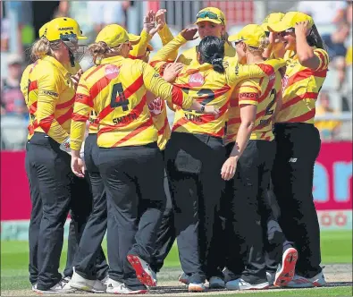  ?? ?? Alana King is mobbed by her team-mates following her hat-trick at Old Trafford yesterday
