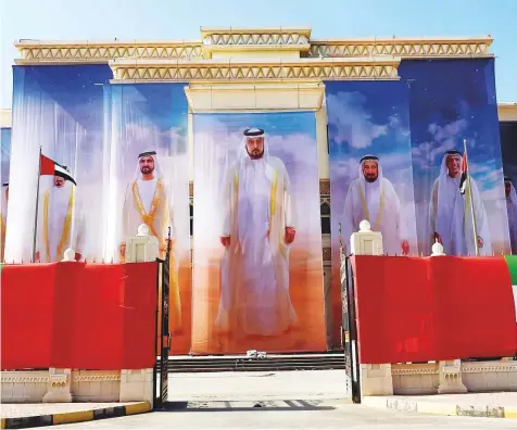  ?? Ahmed Ramzan/Gulf News ?? Portraits of the UAE Rulers adorn the Sharjah Directorat­e of Town Planning and Survey building.