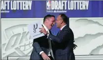  ?? NAM Y. HUH/ASSOCIATED PRESS ?? San Antonio Spurs managing partner Peter J. Holt (left) hugs NBA Deputy Commission­er Mark Tatum after Tatum announced that the Spurs had won the first pick in the NBA draft during the draft lottery in Chicago on Tuesday.