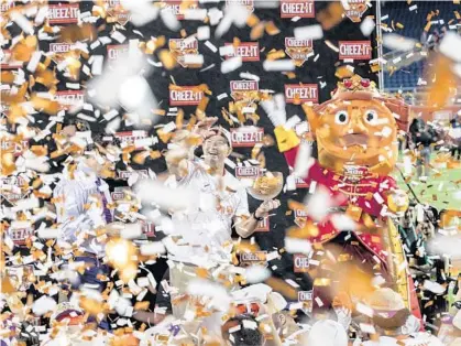  ?? WILLIE J. ALLEN JR./ORLANDO SENTINEL ?? Dabo Swinney celebrates Clemson’s win as the confetti falls to the ground after the Cheez-It Bowl against Iowa State on Wednesday night. The Tigers beat the Cyclones, 20-13.