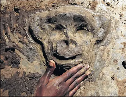  ??  ?? A pupil moulds clay to resemble a monkey’s face.