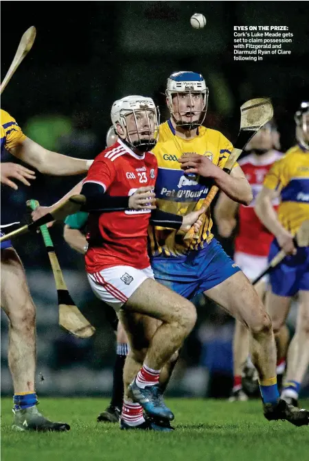  ??  ?? EYES ON THE PRIZE: Cork’s Luke Meade gets set to claim possession with Fitzgerald and Diarmuid Ryan of Clare following in