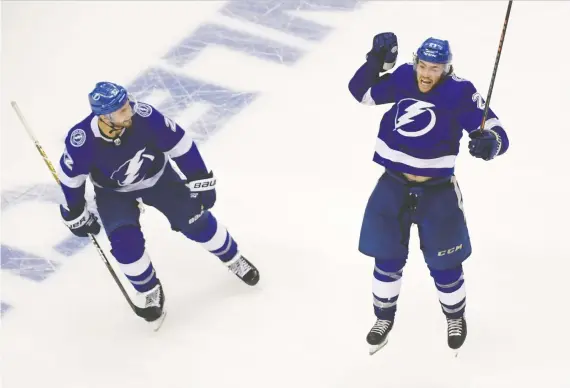  ?? DAN HAMILTON/USA TODAY SPORTS ?? Brayden Point, right, had the game-winner in the fifth overtime period to give the Lightning a 3-2 win over the Blue Jackets in Game 1 of their series.