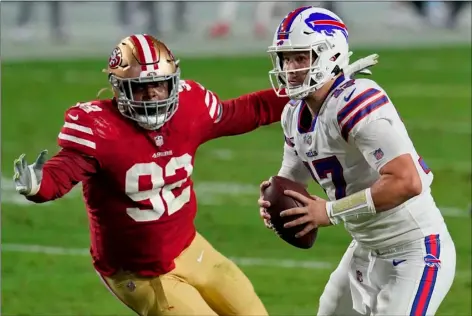  ?? AP PHOTO/ROSS D. FRANKLIN ?? Buffalo Bills quarterbac­k Josh Allen (17) scrambles as San Francisco 49ers defensive end Kerry Hyder (92) pursues during the first half of an NFL football game, Monday, in Glendale, Ariz.