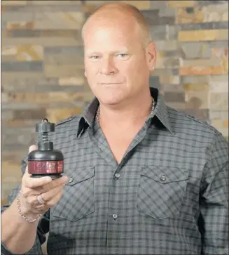  ?? Courtesy, Mike Holmes ?? Mike Holmes holds a radon test kit, which homeowners can use at home to test for safe levels.