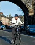  ??  ?? Off again! Ann cycling through her home town in Cumbria