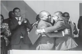  ??  ?? Peace at last … President Nyusi and Renamo leader Ossufo Momade hug after signing peace agreement in July. — Reuters