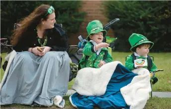  ?? RICK KINTZEL/MORNING CALL ?? Andrea Kushnir of Orefield smiles as her two sons, Keegan, 3, and Leo, 2, are dressed in their St. Patrick’s Day outfits on March 20, 2022, before the 63rd Allentown St. Patrick’s Parade.