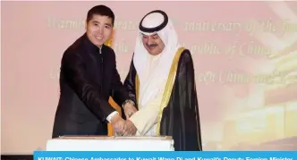  ?? — Photo by Joseph Shagra ?? KUWAIT: Chinese Ambassador to Kuwait Wang Di and Kuwait’s Deputy Foreign Minister Khaled Al-Jarallah cut the cake during the ceremony.