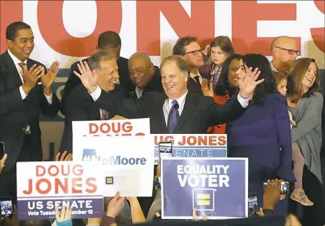  ?? Justin Sullivan/Getty Images ?? Democratic U.S. Senator elect Doug Jones greets supporters during his victory party Tuesday at the Sheraton Hotel. Mr. Jones defeated his Republican challenger Roy Moore to claim Alabama’s U.S. Senate seat that was vacated by attorney general Jeff...