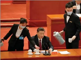  ?? REUTERS ?? Attendants serve tea as Chinese President Xi Jinping delivers a speech at a meeting commending role models of the Beijing 2022 Olympic and Paralympic Winter Games, at the Great Hall of the People in Beijing, China on 8 April 2022.