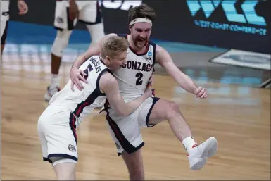  ?? MICHAEL CONROY ?? Gonzaga forward Drew Timme (2) celebrates with Gonzaga guard Martynas Arlauskas (5) after an Elite 8 game against Southern California in the NCAA men’s college basketball tournament at Lucas Oil Stadium, Tuesday, March 30, 2021, in Indianapol­is. Gonzaga won 85-66.