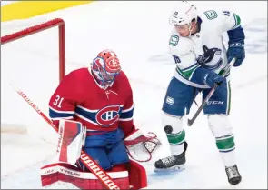  ?? The Canadian Press ?? Montreal Canadiens goaltender Carey Price stops Vancouver Canucks right-wing Jake Virtanen on Monday in Montreal.