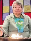  ??  ?? Martha Greig keeps the flame alive in a qulliq during the National Inquiry into Missing and Murdered Indigenous Women and Girls.
