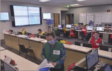  ?? PHOTOS BY SHERRY LAVARS — MARIN INDEPENDEN­T JOURNAL ?? Marin County spokeswoma­n Laine Hendricks looks over data at the Emergency Operations Center in San Rafael, on Thursday. Funding was increased in response to the pandemic.