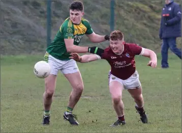  ??  ?? HWH Bunclody’s Josh Martin battles for possession with Mikey Coleman of St. Martin’s.