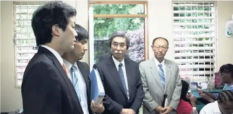  ?? PHOTO BY AMITABH SHARMA ?? Kentaro Sonoura, state minister of foreign affairs of Japan (left), observes industriou­s and talented Jamaican youth making their wellknown “Chupse” accessorie­s at their workshop at the Randolph Lopez School of Hope, which is also home of the JAID....