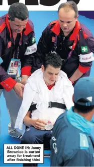  ??  ?? ALL DONE IN: Jonny Brownlee is carted away for treatment after finishing third