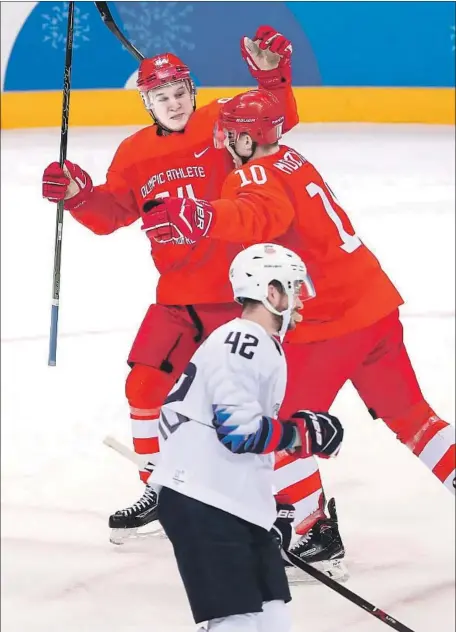  ?? Ronald Martinez Getty Images ?? NIKOLAI PROKHORKIN, top left, of the Olympic Athletes From Russia celebrates after scoring a goal in the first period against the United States during the preliminar­y-round match in Group B at Gangneung Hockey Centre. Prokhorkin scored team’s first two goals.