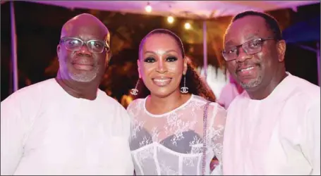  ?? KUNLE OGUNFUYI ?? R-L: Principal Partner, Kenna and Partners, Professor Fabian Ajogwu (SAN); celebrant/Chief Executive Officer, Fine and Country, West Africa, Udo Okonjo; and her Husband, Onyema, during a Gold Coast Sunset Barbecue Dinner, at Labadi Beach Resort to celebrate Udo’s 50th birthday in Accra…weekend