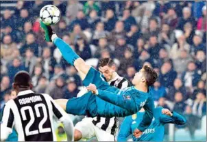  ?? ALBERTO PIZZOLI/AFP ?? Real Madrid forward Cristiano Ronaldo scores with an overhead bicycle kick during their Champions League quarterfin­al first leg with Juventus on April 3.