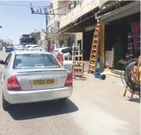  ?? (Adam Rasgon) ?? AN ILLEGAL late-model Mazda with false plates is seen yesterday on the main road of Eizariya.