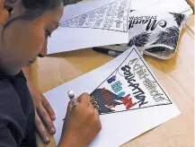  ??  ?? A student creates a theme poster July 13 at Animo Westside Charter Middle School during a summer session to introduce new students to the school they will attend in the fall in the Playa Del Rey area of Los Angeles.