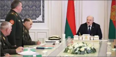  ?? (AP/BelTA/Pool/Nikolai Petrov) ?? Lukashenko (right) attends a meeting Monday with top military officials in Minsk.