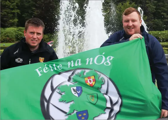  ??  ?? Down’s Diarmuid Cahill (chairperso­n) and Meath’s Ciaran Flynn (secretary) with the Féile flag.