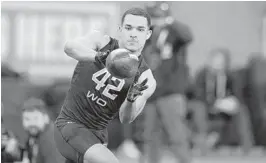  ?? MICHAEL CONROY/AP ?? Former Navy quarterbac­k Malcolm Perry, seen running a drill at the NFL scouting combine, signed with the Dolphins on Tuesday and will vie for playing time at wide receiver.