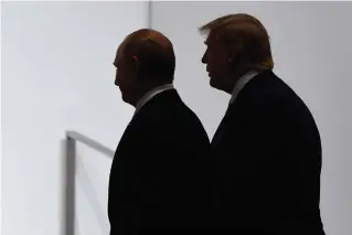  ?? (AP Photo/Susan Walsh, File) ?? In this June 28, 2019, file photo, President Donald Trump and Russian President Vladimir Putin walk to participat­e in a group photo at the G20 summit in Osaka, Japan. The Trump administra­tion says it wants out of the Open Skies Treaty because Russia is violating the pact and imagery collected during the flights can be obtained quickly at less cost from U.S. or commercial satellites.