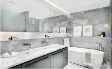  ??  ?? Bathrooms will have wall-mounted fixtures, marble ledges and feature lighting.