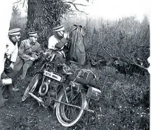  ??  ?? Members of a small group distinguis­hed as the ‘enemy’ by their white sweaters and cap bands hide behind a hedge with their machines. The 42 dispatch riders they ‘captured’ were sent on their way to try again – by much less obvious routes.