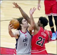  ?? CHARLES REX ARBOGAST — THE ASSOCIATED PRESS ?? The Wizards’ Robin Lopez shoots as the Bulls’ Thaddeus Young defends on Feb. 8 in Chicago.