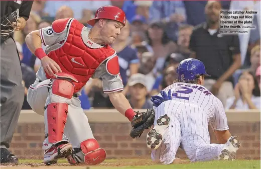  ?? JONATHAN DANIEL/GETTY IMAGES ?? Phillies catcher Andrew Knapp tags out Nico Hoerner at the plate in the fourth.