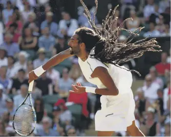  ??  ?? 2 Andy Murray makes a return against Dustin Brown on Centre Court. Above: Brown serves in the second-round encounter. Right: Murray accelerate­s to return Brown’s serve, giving the crowd more action than they saw from Novak Djokovic, inset, the day before.