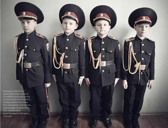  ?? ?? Young boys barely 6 or 7 years old posing in uniform in a military boarding school. Since the start of the conflict, military schools have been full, and parents send increasing­ly younger children there, Kyiv, January 2018.
Aude Osnowycz © All rights reserved.