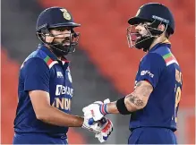  ?? — AFP ?? Rohit Sharma (left) speaks to Virat Kohli in this file photo.