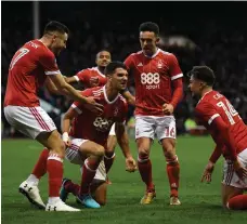  ?? Getty ?? Eric Lichaj, second left, celebrates with his Nottingham Forest teammates as they defeated FA Cup holders Arsenal 4-2